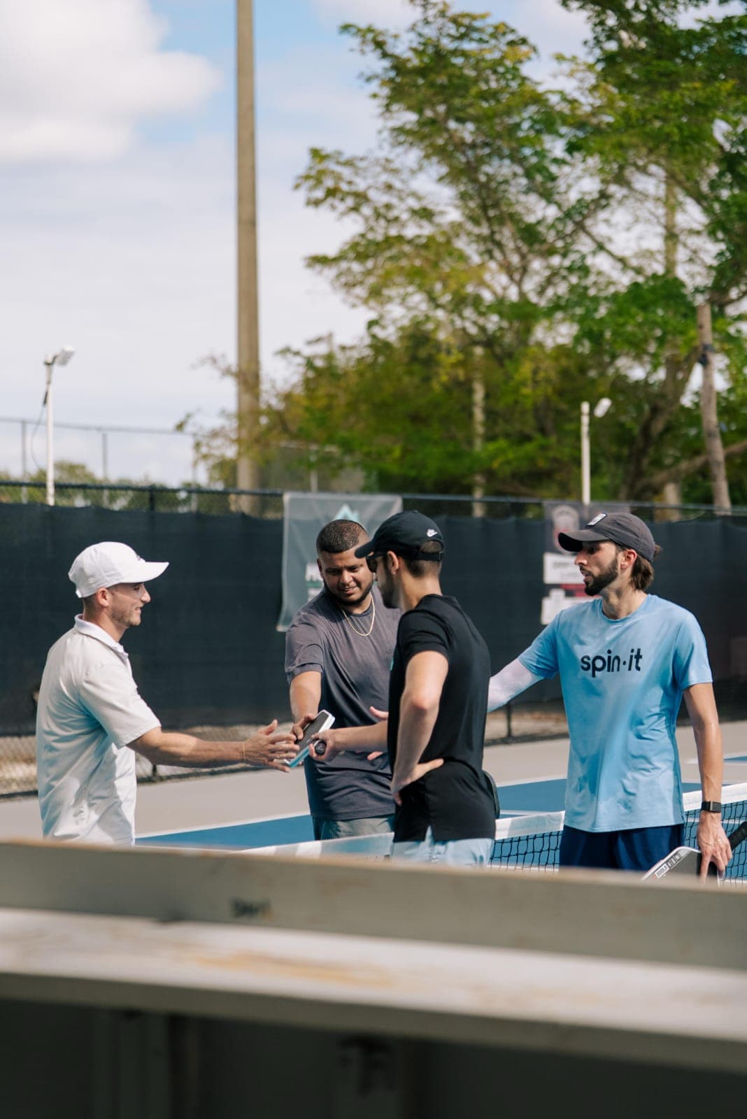 Pickleball players greeting on court